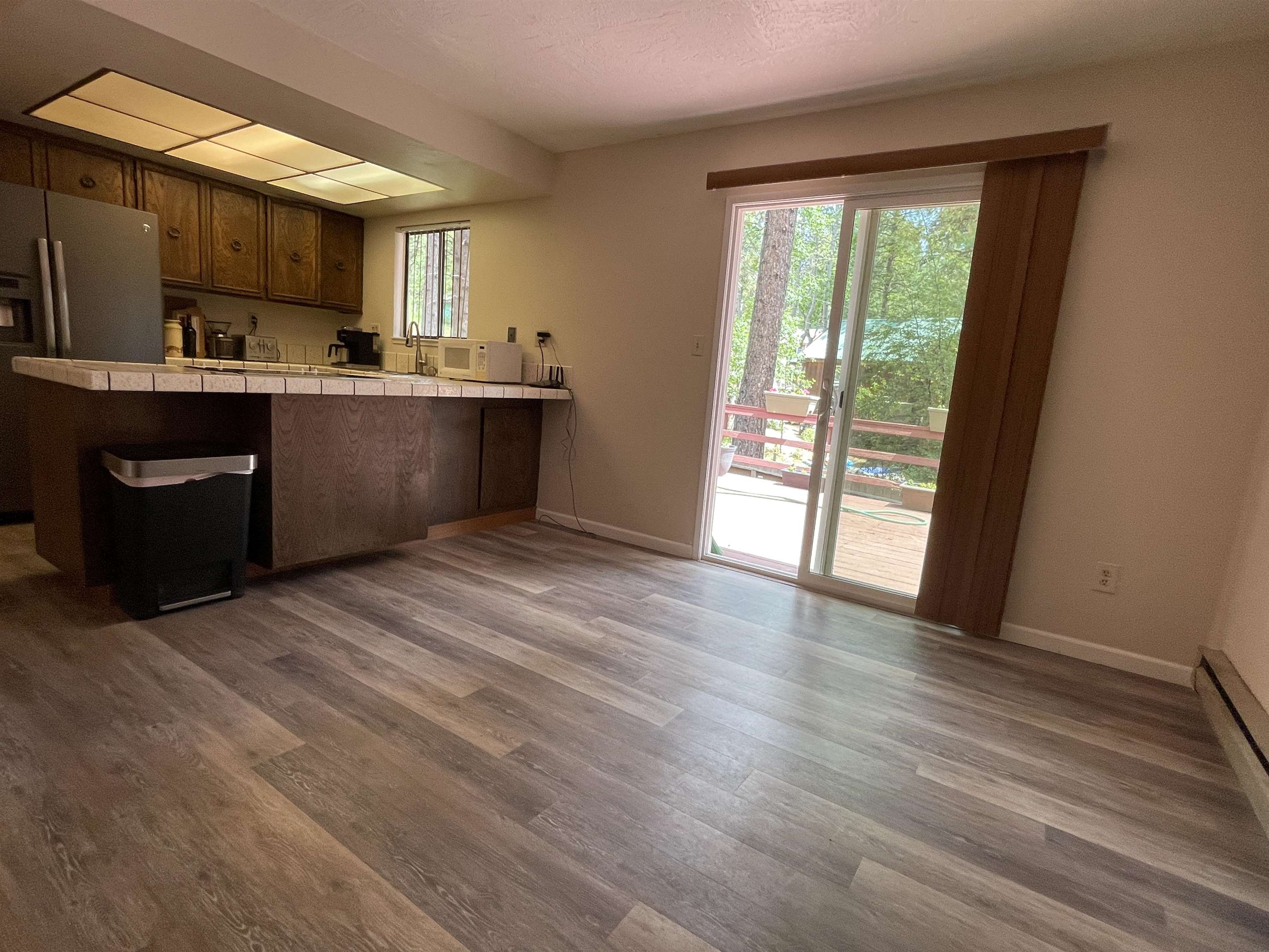 302 Mountain View Road Calpine, CA 96124 - Photo 14 of 26 a kitchen with stainless steel appliances a sink cabinets and wooden floor