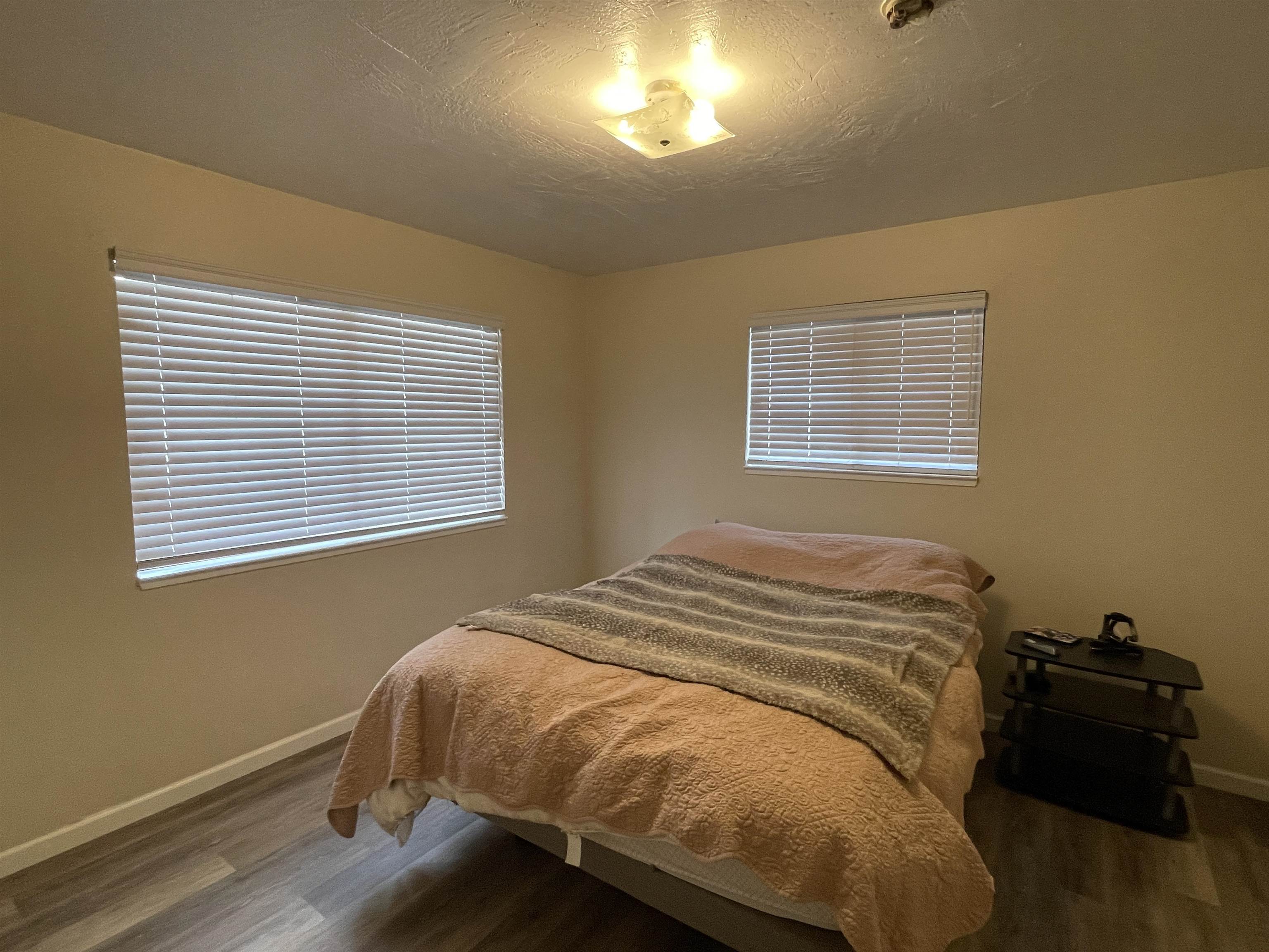 302 Mountain View Road Calpine, CA 96124 - Photo 17 of 26 a bed sitting in a bedroom next to a window