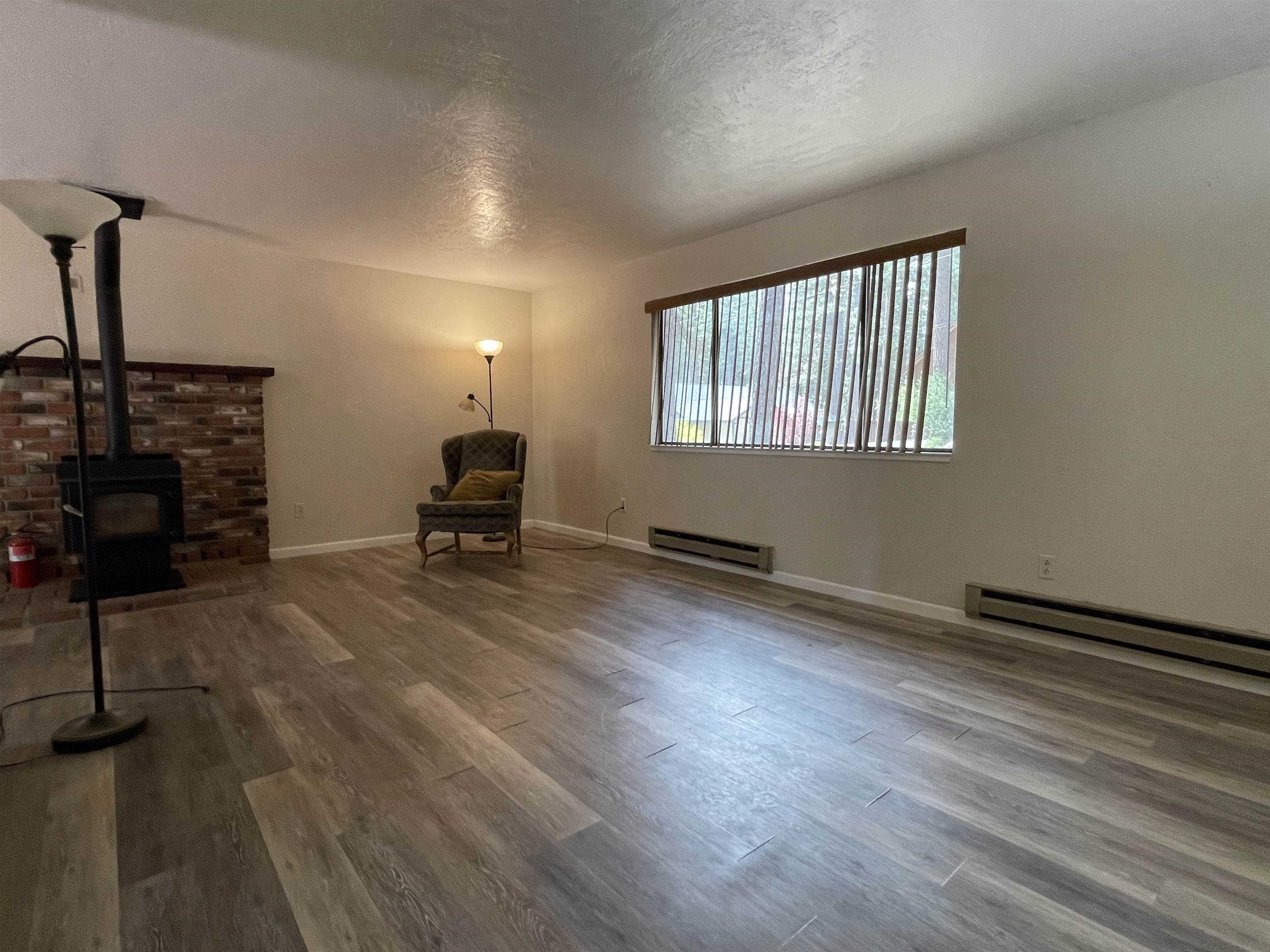 302 Mountain View Road Calpine, CA 96124 - Photo 8 of 26 a living room with furniture and a fireplace