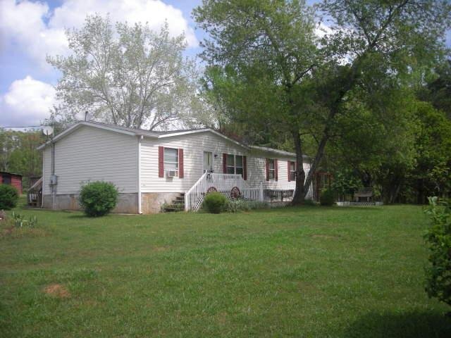 2183 Garner Road Gay, GA 30218 - Photo 1 of 1 a front view of a house with a garden
