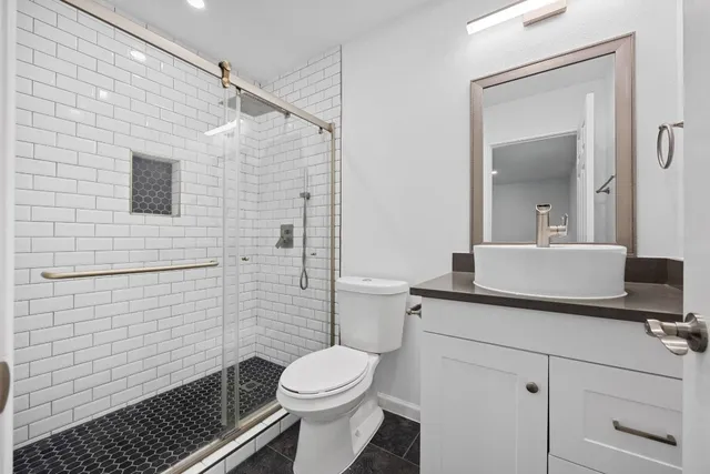 a bathroom with a sink toilet and shower
