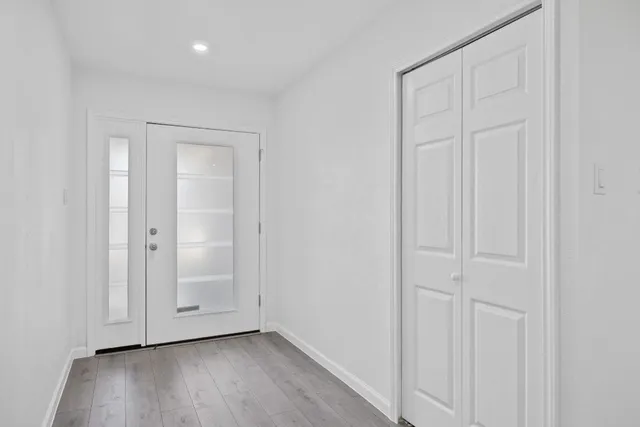 an empty room with wooden floor