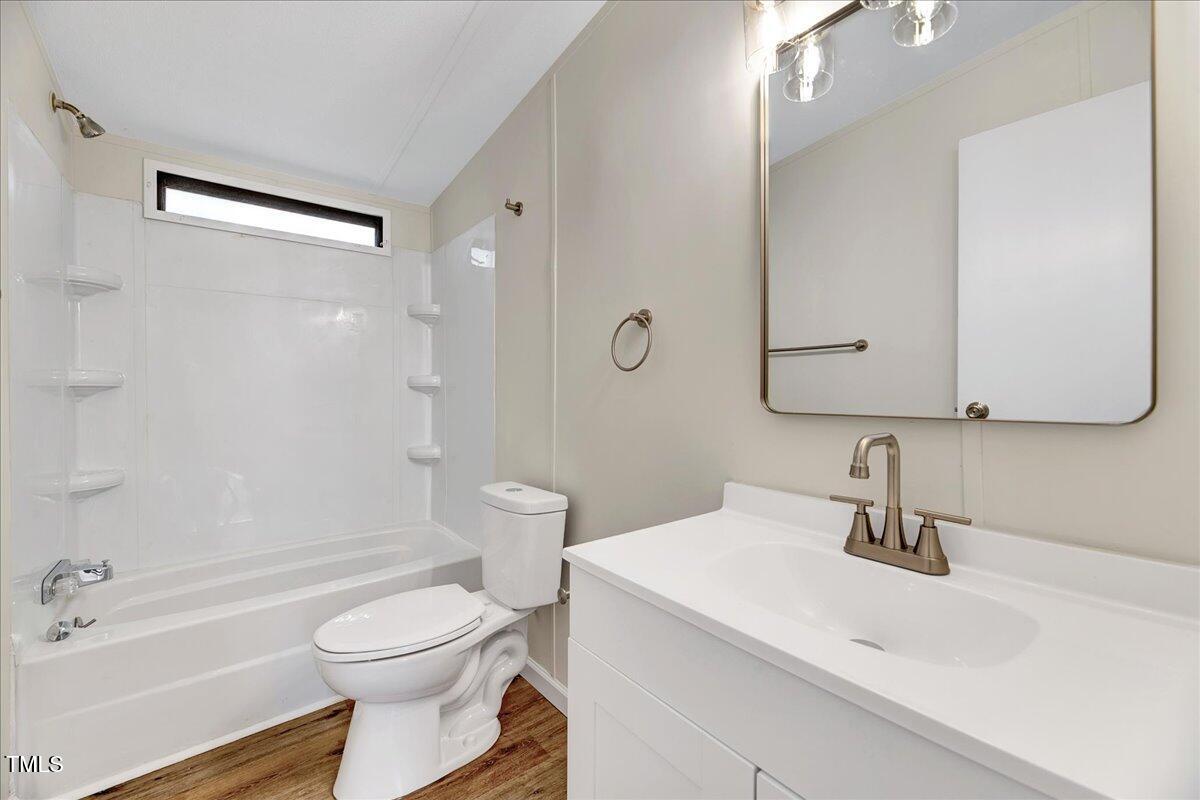 10942 Simms Road Bailey, NC 27807 - Photo 29 of 44 a bathroom with a sink a toilet and shower