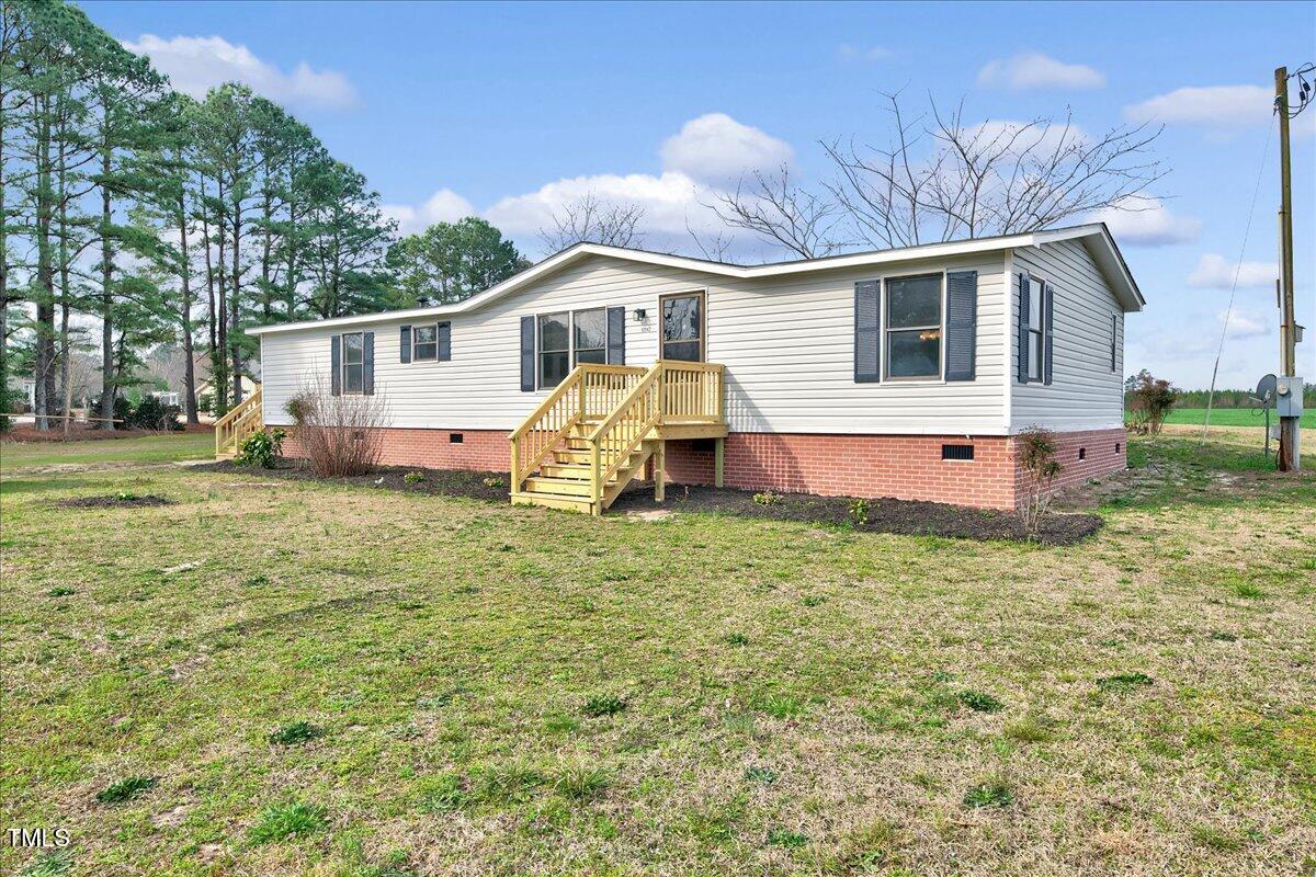 10942 Simms Road Bailey, NC 27807 - Photo 2 of 44 a view of a house with a backyard