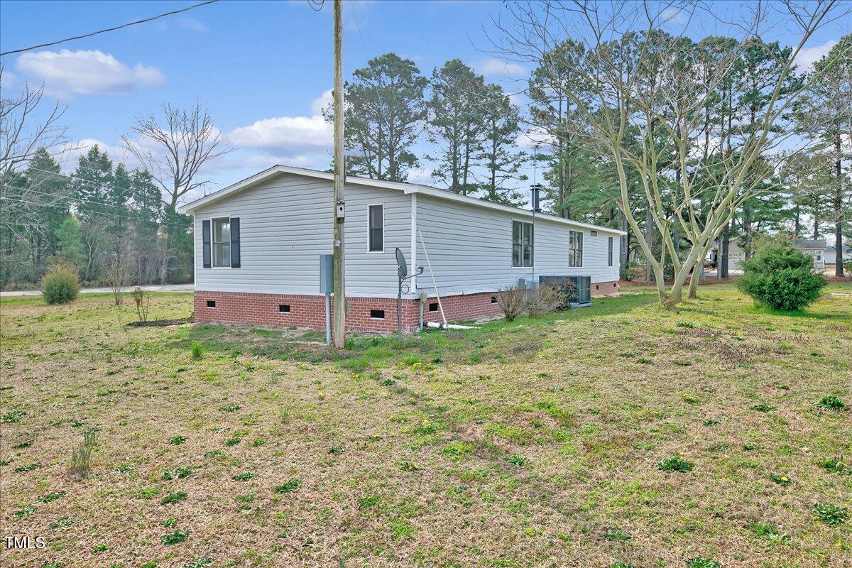 10942 Simms Road Bailey, NC 27807 - Photo 35 of 44 a backyard of a house with table and chairs