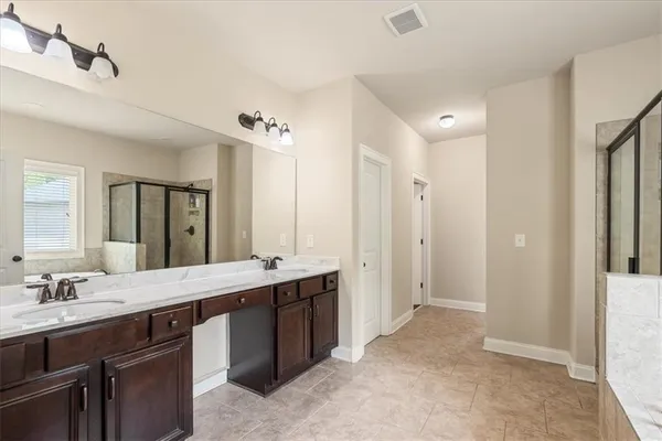 a spacious bathroom with a double vanity sink mirror and double