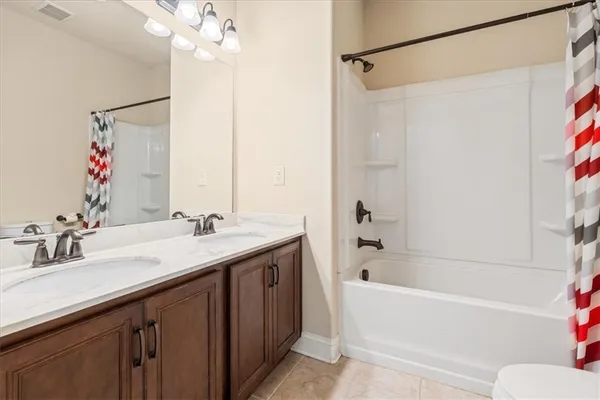 a bathroom with a tub sink and mirror
