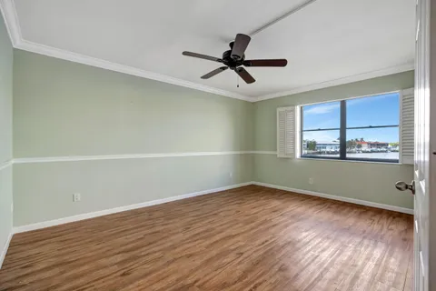 a view of a room with wooden floor and window