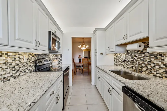 a kitchen with granite countertop a sink and cabinets