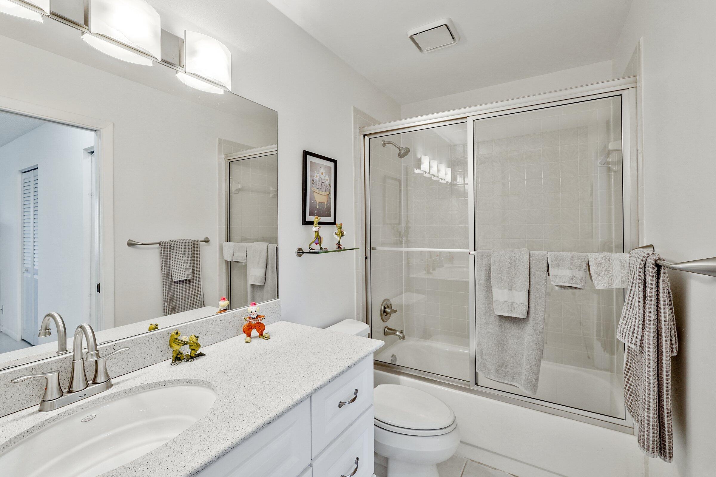 13960 Nesting Way, Unit C Delray Beach, FL 33484 - Photo 20 of 30 a bathroom with a sink toilet and shower