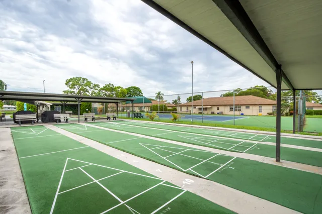 an aerial view of a house with a garden and lake view
