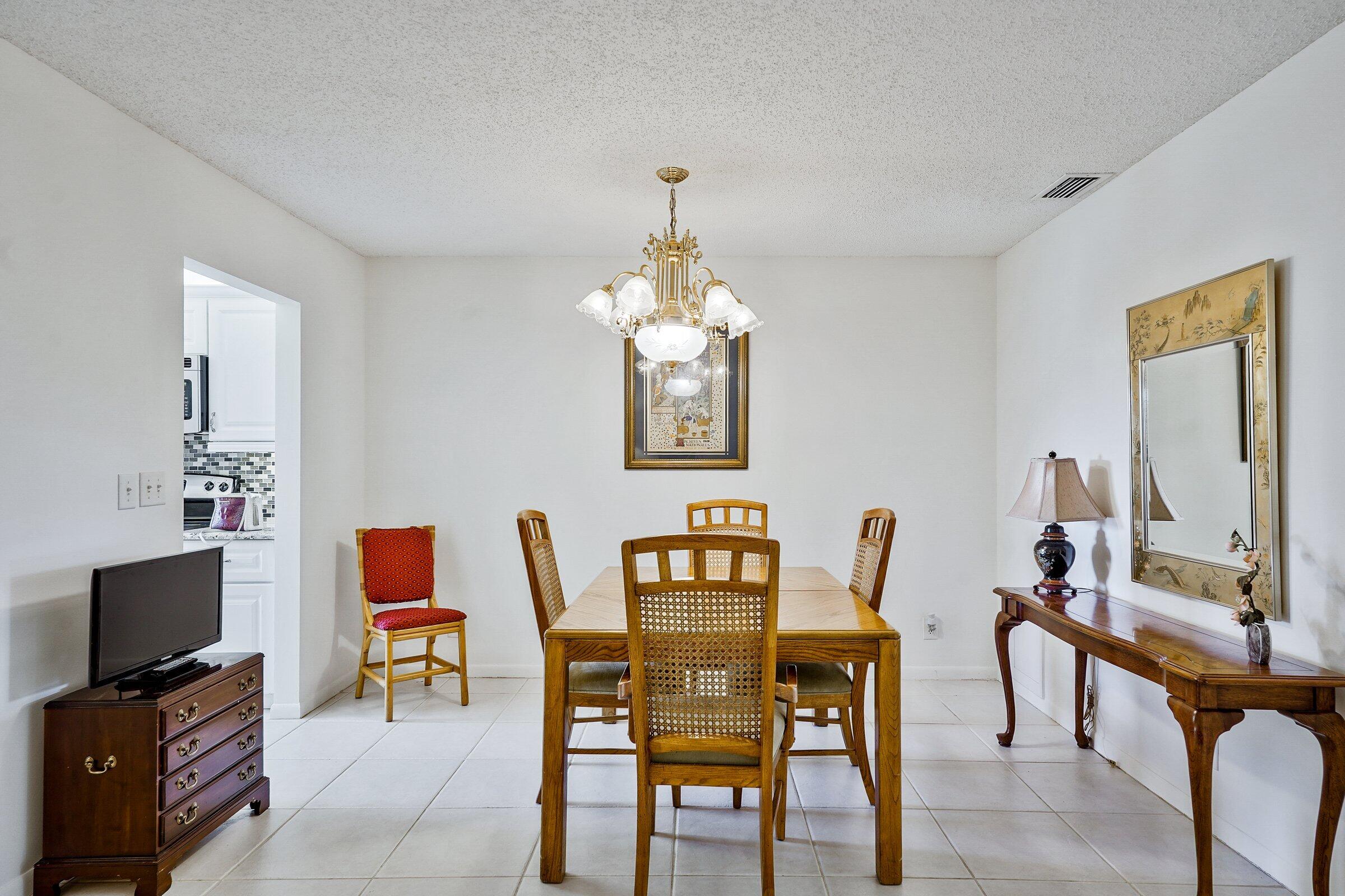 13960 Nesting Way, Unit C Delray Beach, FL 33484 - Photo 10 of 30 a dining room with furniture and window