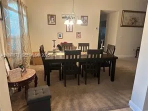 a view of a dining room with furniture and window