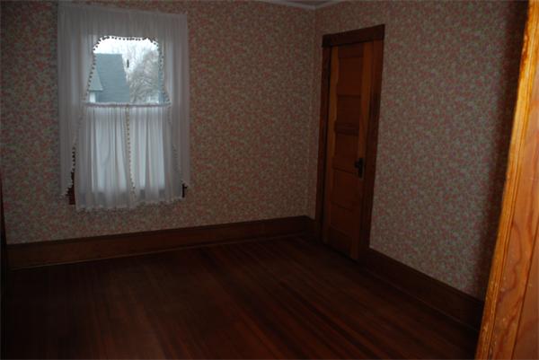 125 Stockman Street Springfield, MA 01104 - Photo 8 of 10 a view of an empty room with wooden floor and a window