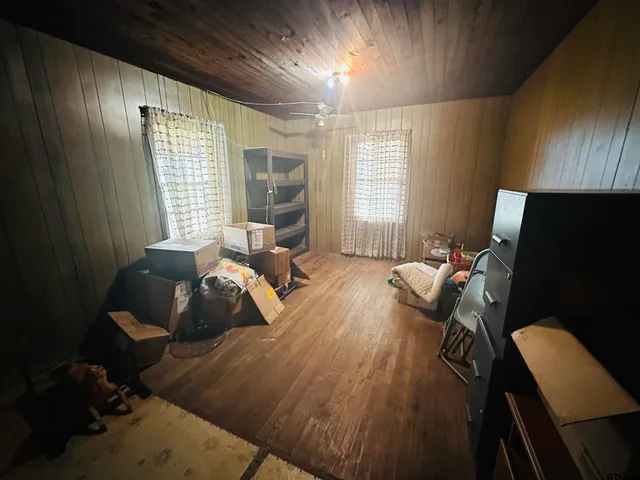 a bed room with a bed window and a chair