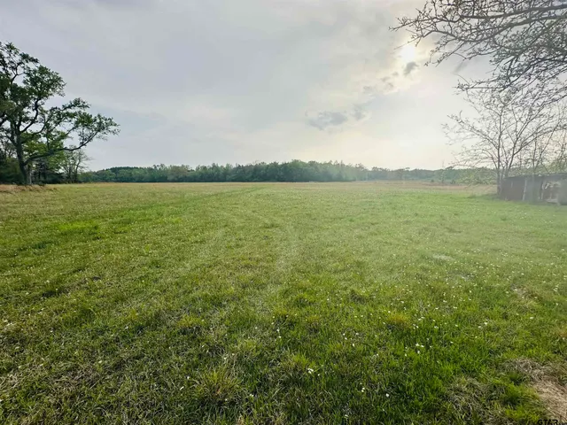 a view of a lake and green valley