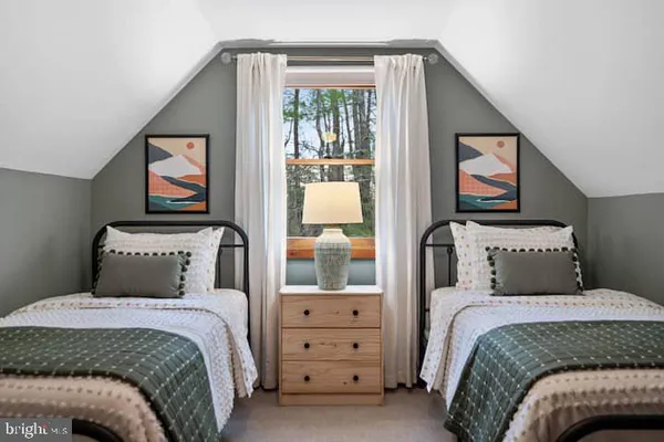 a bedroom with a bed and a painting on the wall