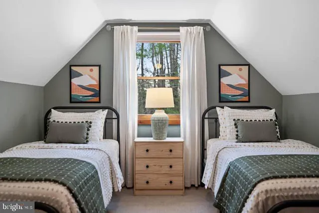 a bedroom with a bed and a painting on the wall