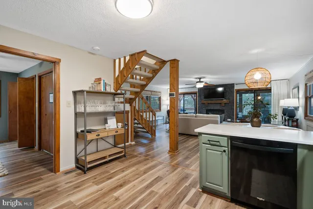 a room with fireplace cabinets and a wooden floor