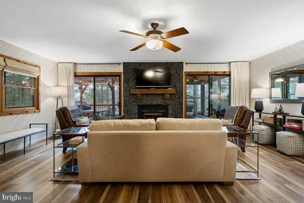 a living room with furniture and floor to ceiling windows