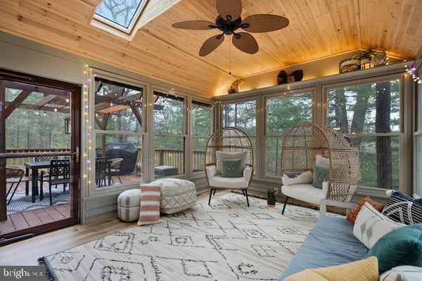 a living room with furniture and a floor to ceiling window