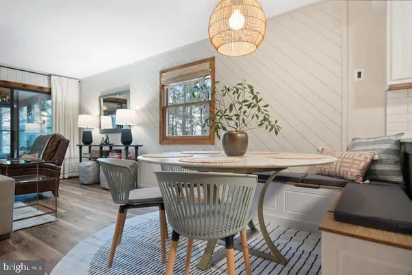 a view of a dining room with furniture wooden floor and a chandelier