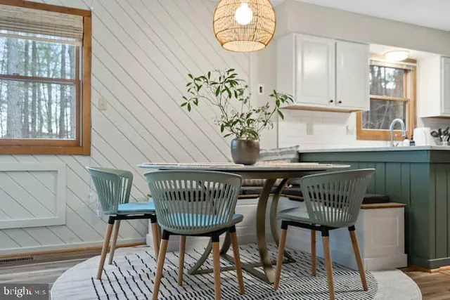 a view of a dining room with furniture and chandelier
