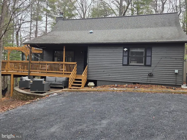a view of a house with cars parked in front of a house