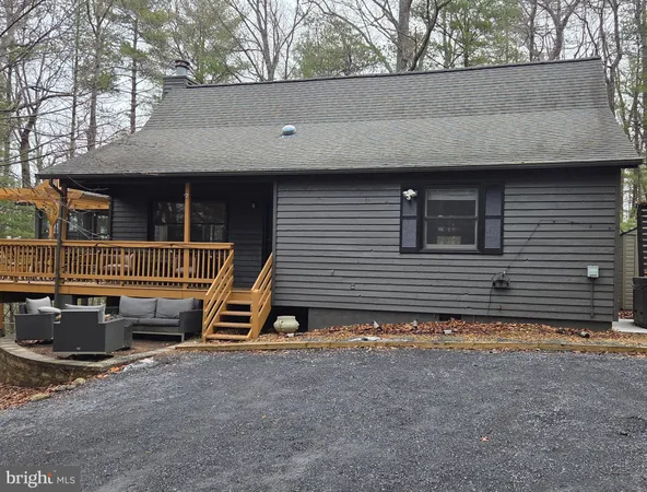 a view of a house with a yard and wooden fence