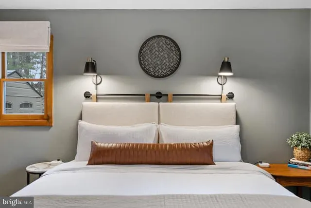 a bedroom with a bed and window