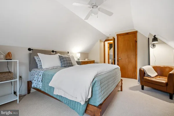 a spacious bedroom with a bed and a couch