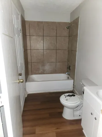 a bathroom with a toilet and a shower