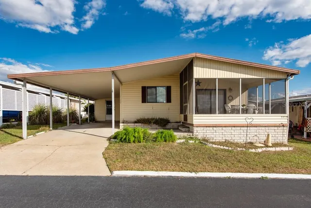 a view of house with backyard and porch