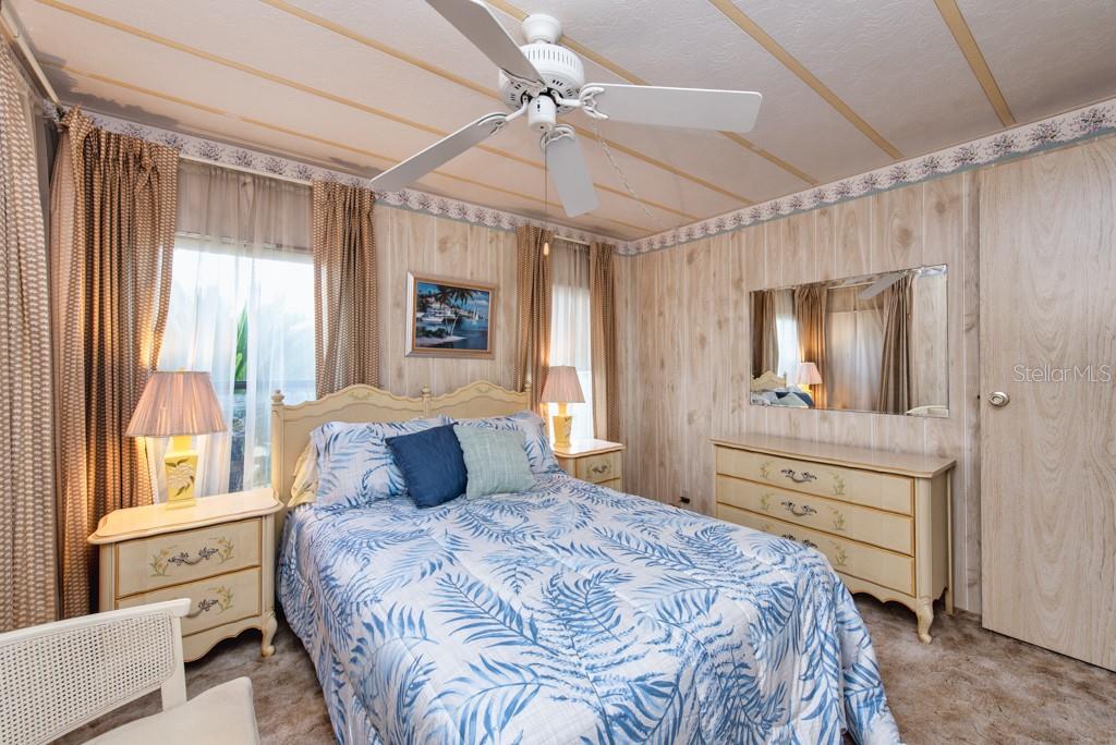 7152 El Torro Street Zephyrhills, FL 33541 - Photo 16 of 35 a bedroom with a large bed and a window