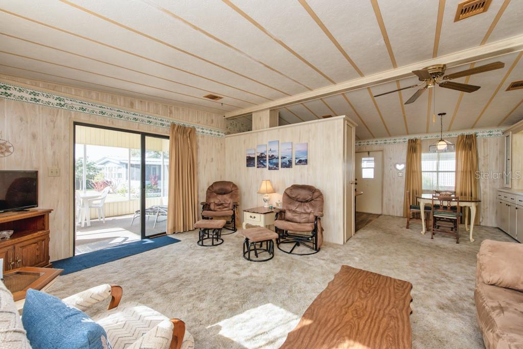 7152 El Torro Street Zephyrhills, FL 33541 - Photo 3 of 35 a living room with furniture window and a table