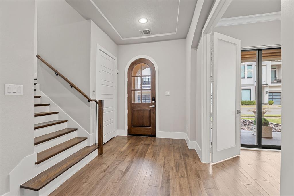 7854 Element Avenue Plano, TX 75024 - Photo 10 of 38 Foyer featuring arched walkways, light wood-style flooring, stairway, and recessed lighting
