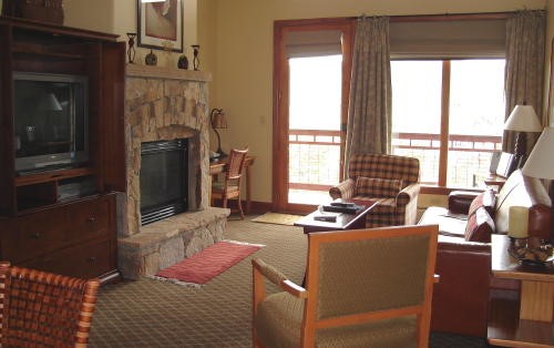 500 Village Road, Unit 206 217 Breckenridge, CO 80424 - Photo 3 of 20 a living room with furniture a large window and a fireplace