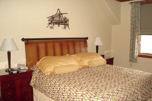 500 Village Road, Unit 206 217 Breckenridge, CO 80424 - Photo 8 of 20 a bedroom with a bed and a lamp on dresser