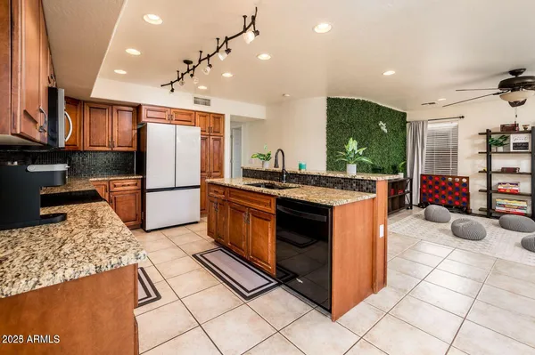 a kitchen with stainless steel appliances granite countertop a stove a refrigerator and a oven
