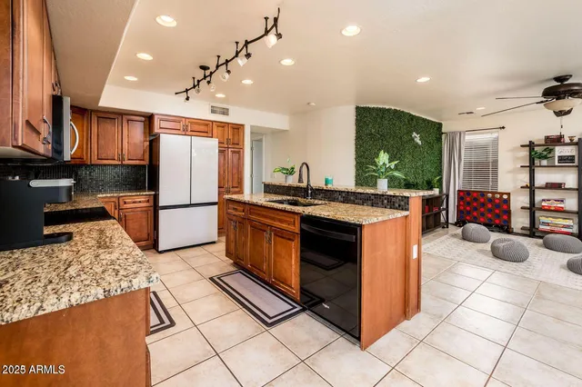 a kitchen with stainless steel appliances granite countertop a stove a refrigerator and a oven
