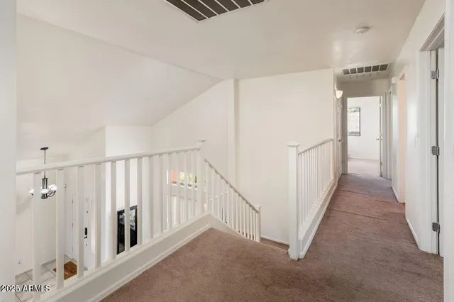 a view of a hallway with staircase