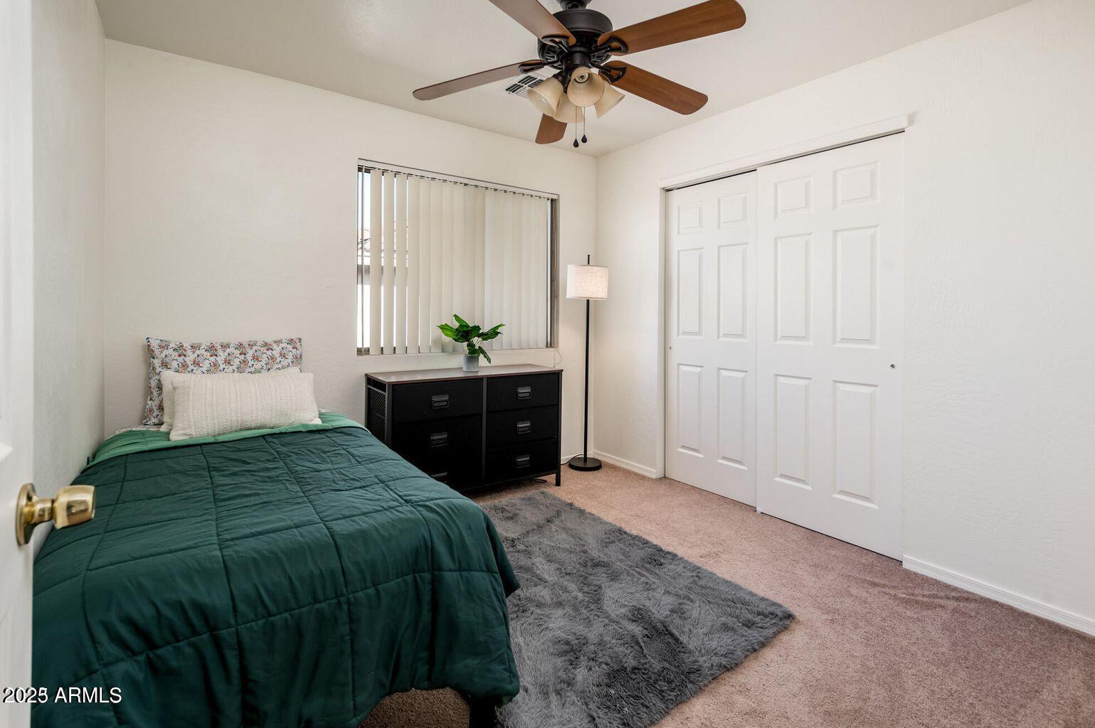 13604 West Rovey Avenue Litchfield Park, AZ 85340 - Photo 21 of 33 a bedroom with a bed and a chandelier