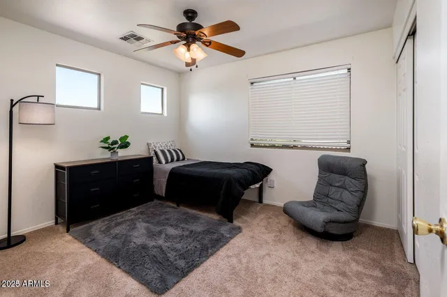 a bedroom with a bed and window