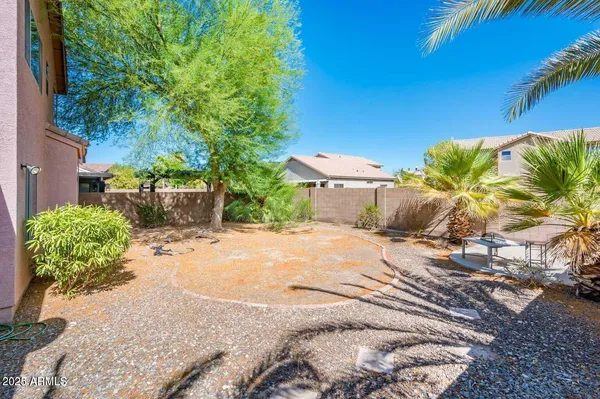 a view of a backyard with plants and a patio