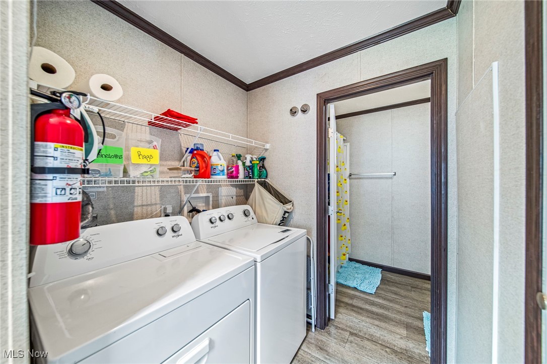 202 West Main Road, Unit LOT 13 Conneaut, OH 44030 - Photo 17 of 23 Laundry area with ornamental molding, light wood-type flooring, separate washer and dryer, and water heater