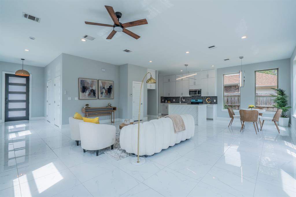 3610 Vilbig Road Dallas, TX 75212 - Photo 4 of 29 Open-concept living space featuring high ceilings, recessed lighting, and large format white tile flooring