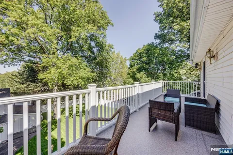 a view of two chairs in the balcony