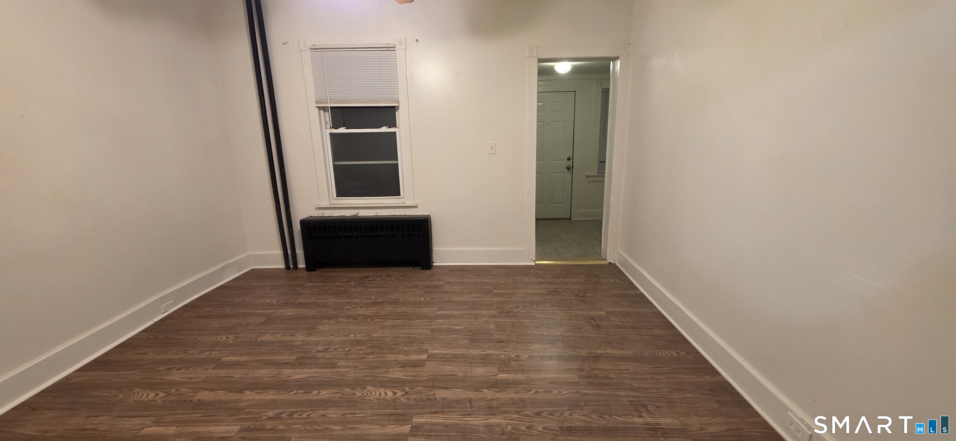 137 Birch Street, Unit 139 Manchester, CT 06040 - Photo 3 of 14 a view of an empty room with wooden floor and cabinets