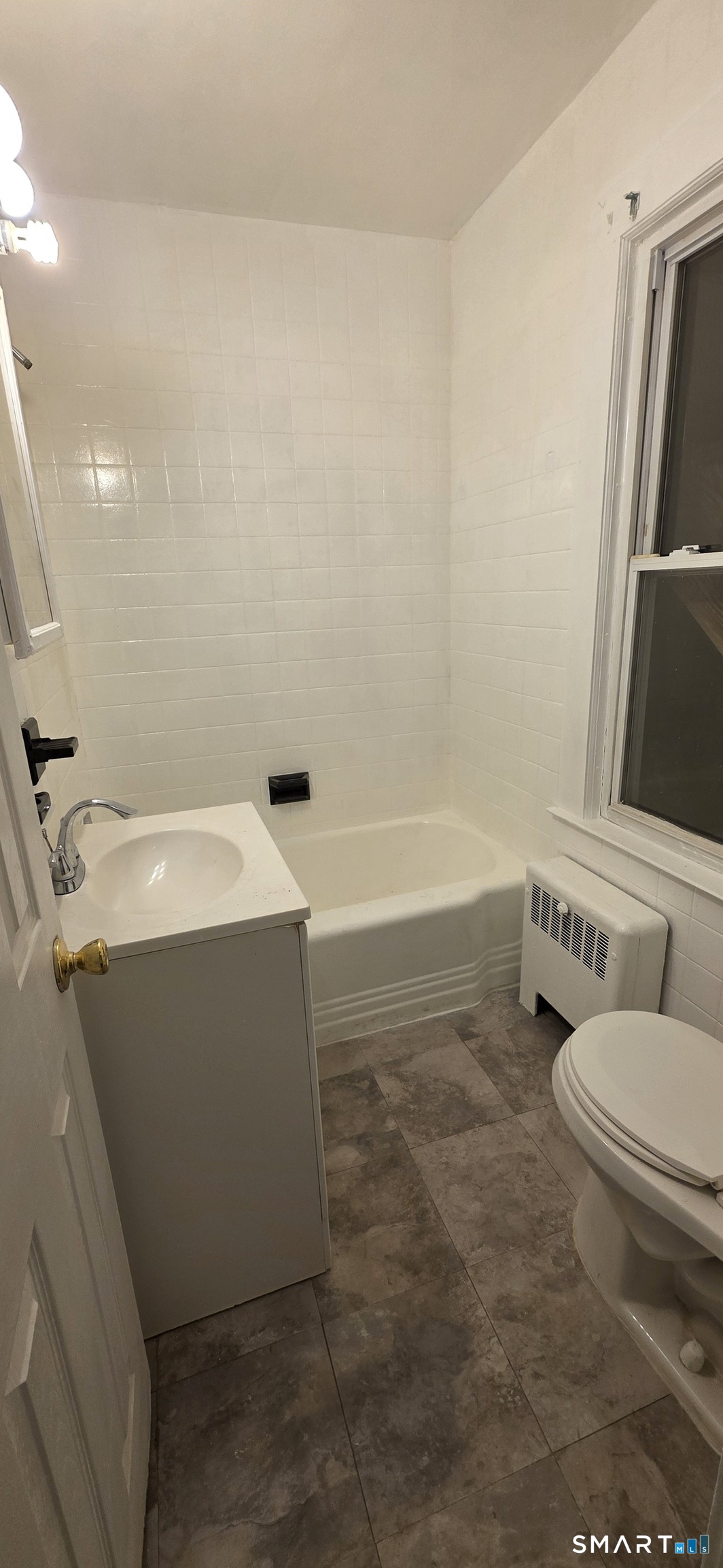 137 Birch Street, Unit 139 Manchester, CT 06040 - Photo 5 of 14 a bathroom with a sink toilet and tub