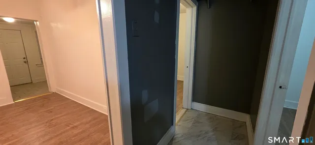 a view of hallway with wooden floor